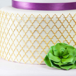 Detail image of lace piece on a cake.