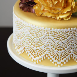 image of cake with lace on it