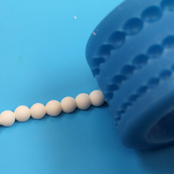 Image of pearls being unmolded.