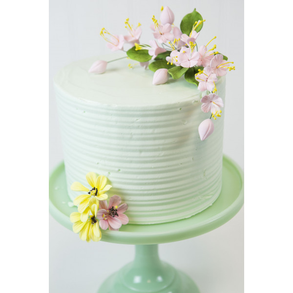 Image of flower on a cake with other flowers.