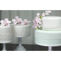 Image of multiple cakes decorated with cake lace.